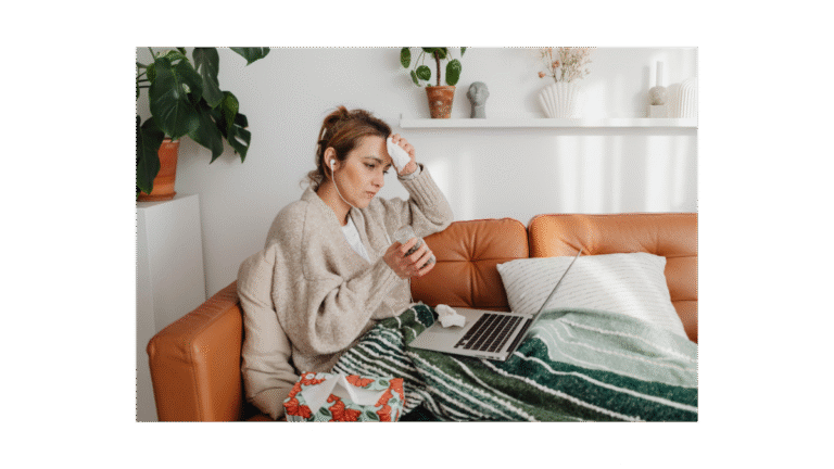 Lady on sofa looking at laptop stressed