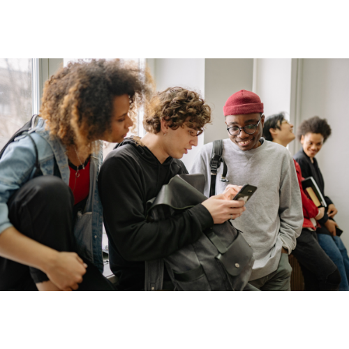 Coaching students looking at a mobile phone