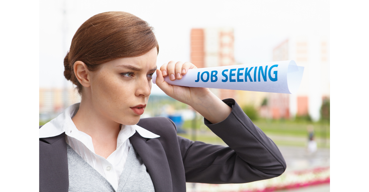 Woman looking through a paper scope searching for a job transition