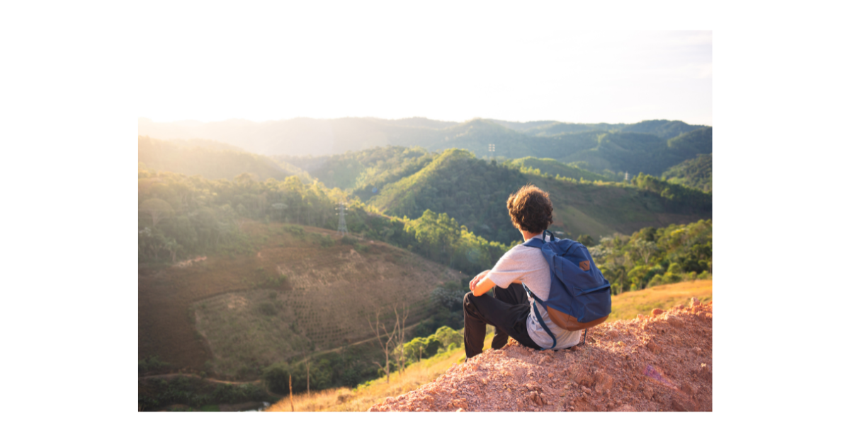 Man sat chilling on a hill top